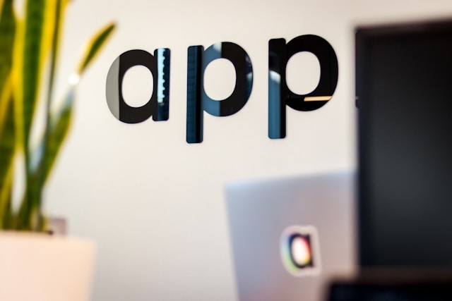 black-app-sign-on-white-wall
